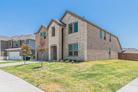 View of front facade with a garage and a front lawn