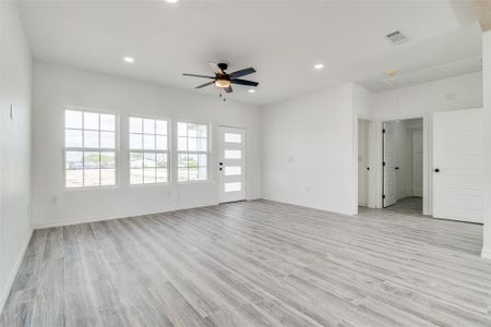 Spare room featuring light wood-type flooring and ceiling fan