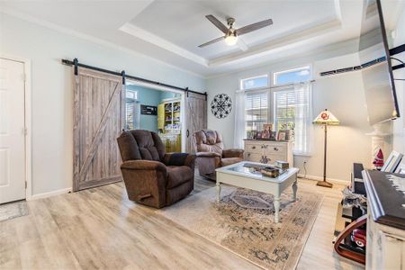 Great Room with transom windows, tray ceiling and barn doors to flex space!