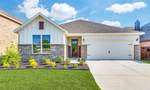 View of front of home with a garage and a front yard