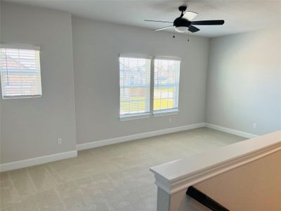 Stairs lead to spacious game room that also includes a generously sized closet for storage.