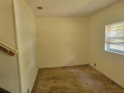 Spare room featuring crown molding and carpet floors