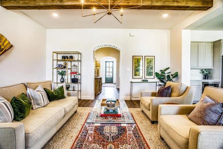 Living room featuring beam ceiling and wood-type flooring