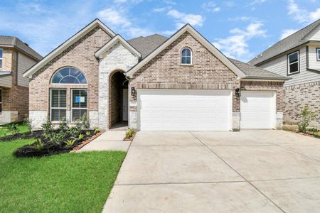 This home boasts lush green grass and meticulous landscaping. Its premium elevation showcases an exquisite blend of brick and stone features, complemented by modern coach lighting