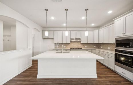 Spacious kitchen with oversized island *real home pictured