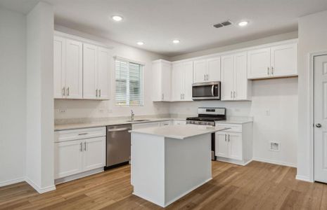 Spacious kitchen with oversized island *real home pictured