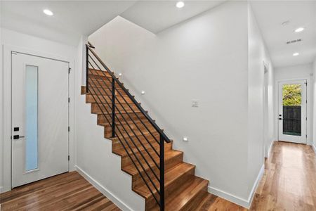 Stairway featuring wood-type flooring