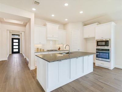 Gourmet kitchen with built-in appliances, tons of counter and cabinet space and gorgeous island with expansive breakfast bar.  Notice the cabinets in the island.