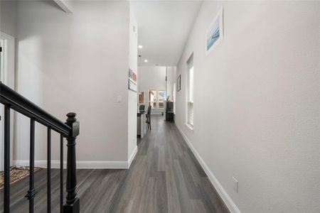 Corridor with dark hardwood / wood-style flooring