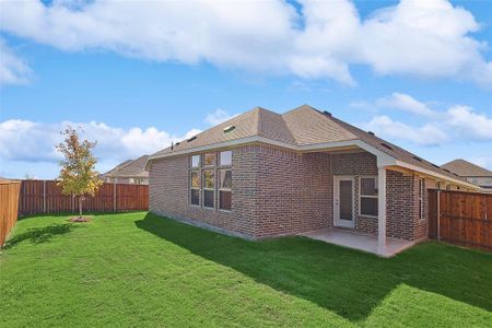 Rear view of house with a patio area and a yard