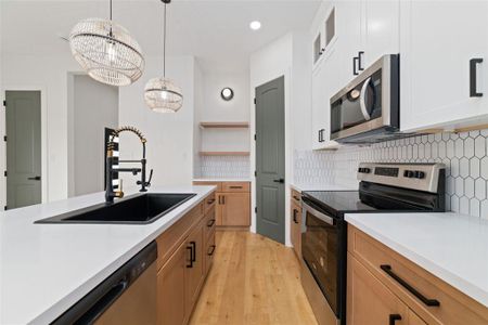 The gourmet kitchen features an electric range, stainless steel microwave, dry bar, and a spacious walk-in pantry, providing everything you need for an ideal culinary excellence.