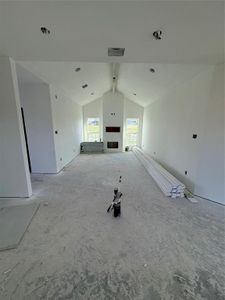 Living room featuring vaulted ceiling with beams