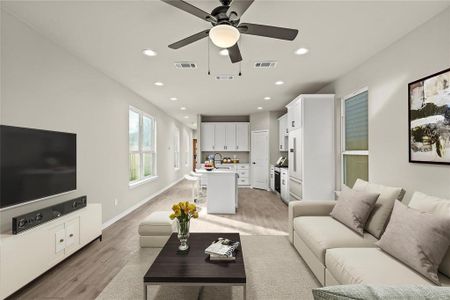 Living room featuring light hardwood / wood-style floors, ceiling fan, and sink