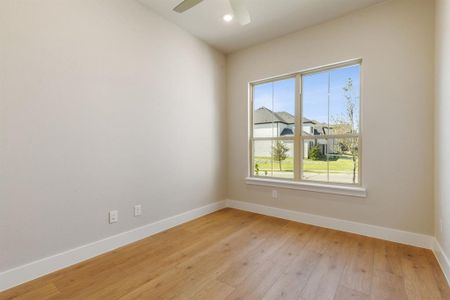 Spare room with ceiling fan and light hardwood / wood-style flooring