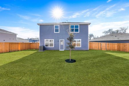 Back of house with a yard and central AC unit