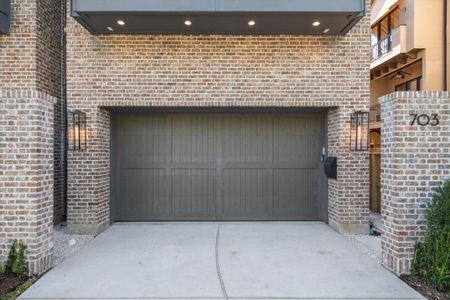 A custom brick privacy wall, adorned with carefully curated landscaping and modern black address numbers, guides you to the front door, enhancing the aesthetic appeal the home's entrance. Two car garage with double wide driveway for four car parks.