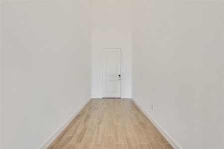 Corridor with light wood-type flooring