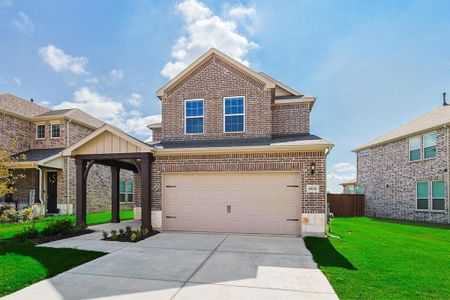 View of front facade featuring a garage and a front yard