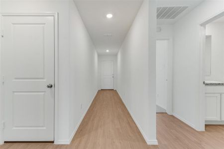 Corridor with light hardwood / wood-style floors