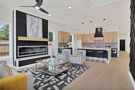 Living room featuring ceiling fan and light hardwood / wood-style floors