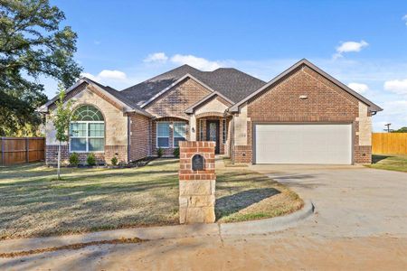 View of front facade with a front lawn and a garage