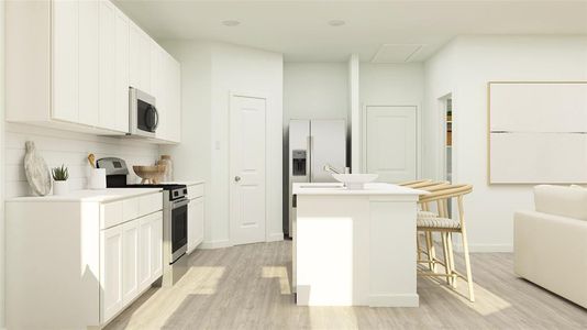 Kitchen featuring light hardwood / wood-style flooring, an island with sink, white cabinets, a kitchen bar, and appliances with stainless steel finishes