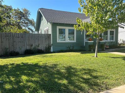 View of side of property featuring a lawn