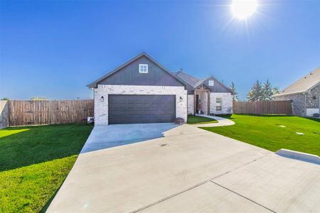 View of front of home featuring a garage and a front lawn