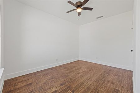 Unfurnished room with ceiling fan and wood-type flooring