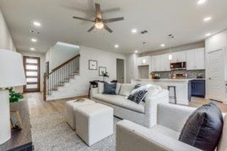 Living room featuring light hardwood / wood-style floors and ceiling fan