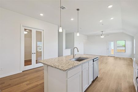 Kitchen featuring ceiling fan, white cabinets, sink, dishwasher, and light hardwood / wood-style floors