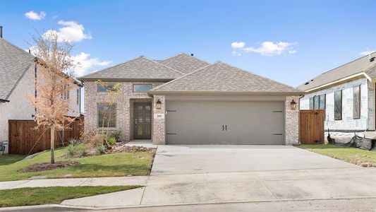 View of front of property with a garage and a front yard