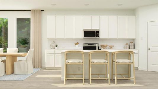 Kitchen with a kitchen bar, white cabinets, light hardwood / wood-style flooring, and tasteful backsplash