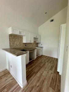 Beautiful kitchen with granite countertops, includes refrigerator and built in microwave