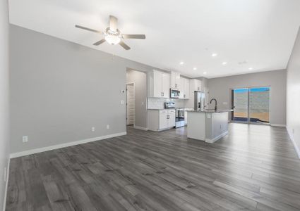 Open-concept layout with the spacious living room leading into the kitchen.