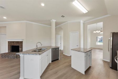 Kitchen featuring white cabinets, an island with sink, appliances with stainless steel finishes, and sink