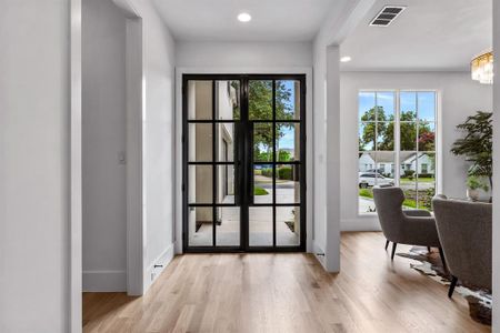 Doorway featuring french doors, light hardwood / wood-style flooring, and a wealth of natural light