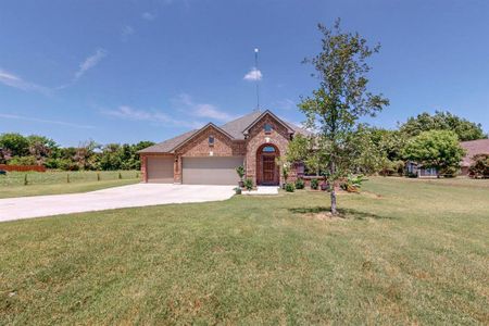 View of front of house featuring a garage and a front yard