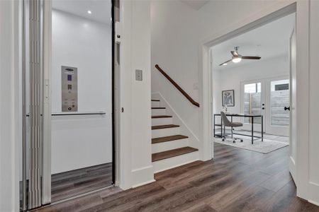 A partial view of the first-floor bedroom, which can also serve as a study or an office, along with the staircase leading to the second floor. Notice the elevator, which is convenient for bringing your stuff up to the 2nd, 3rd, or 4th floor!