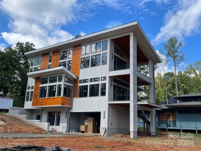 Rear of home with decks and garage entrance