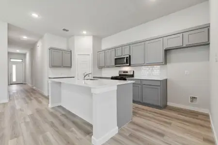 Kitchen in the Quartz home plan by Trophy Signature Homes – REPRESENTATIVE PHOTO