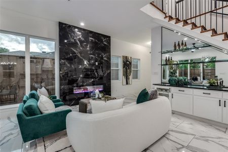 Living room featuring electric fireplace and bar.