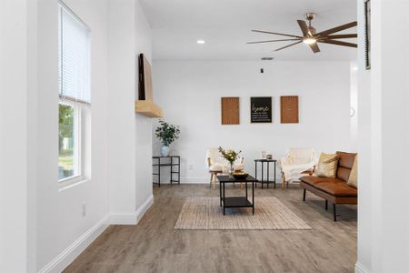 Sitting room with ceiling fan and light hardwood / wood-style flooring