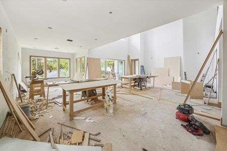 Additional view of the family room showcasing the gas log fireplace centered in the space. Masonry accents will bring interested to the space while white oak built in cabinets flank either side. Photo as of 7/30/24