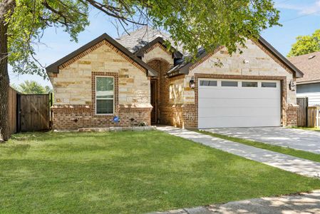 View of front facade featuring a front lawn and a garage