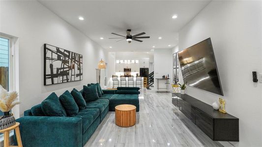 Living room featuring ceiling fan and light hardwood / wood-style floors