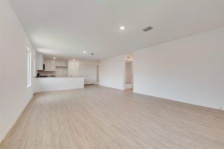 Unfurnished living room featuring light wood-type flooring