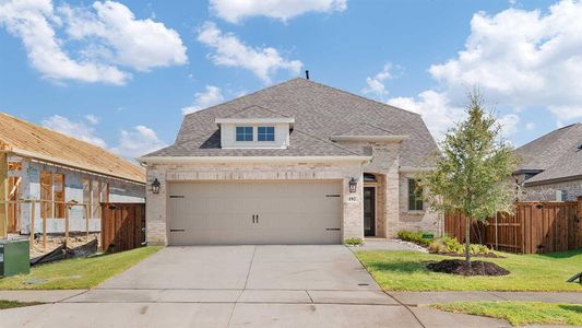 View of front facade with a garage and a front lawn