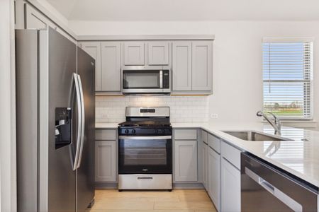 Kitchen in the Ash home plan by Trophy Signature Homes – REPRESENTATIVE PHOTO