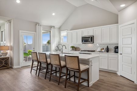 Kitchen in the Wimbledon home plan by Trophy Signature Homes – REPRESENTATIVE PHOTO